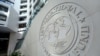 FILE - The International Monetary Fund logo is seen inside its headquarters at the end of the IMF/World Bank annual meetings in Washington.